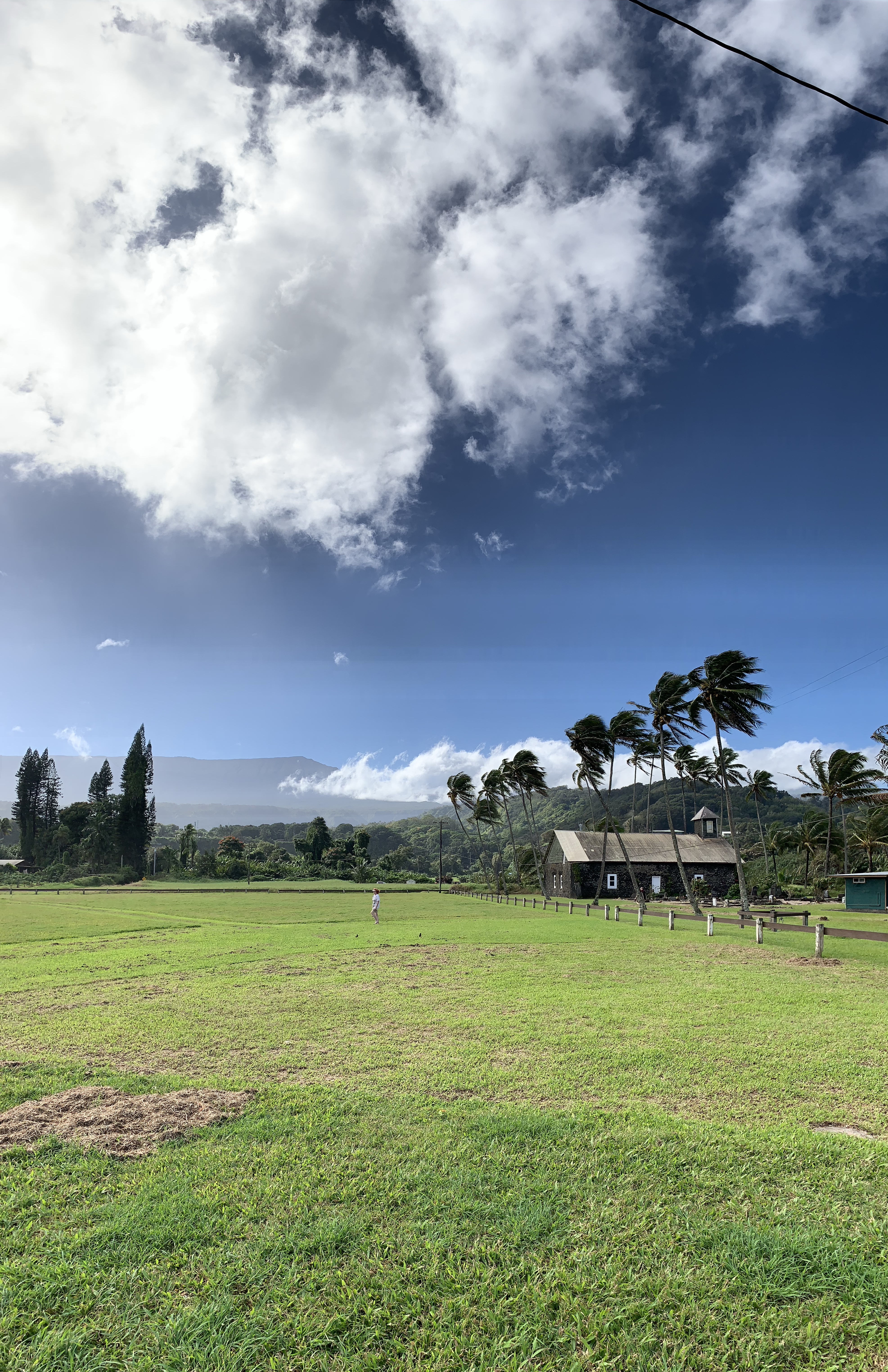 stone church in green fields under blue sky